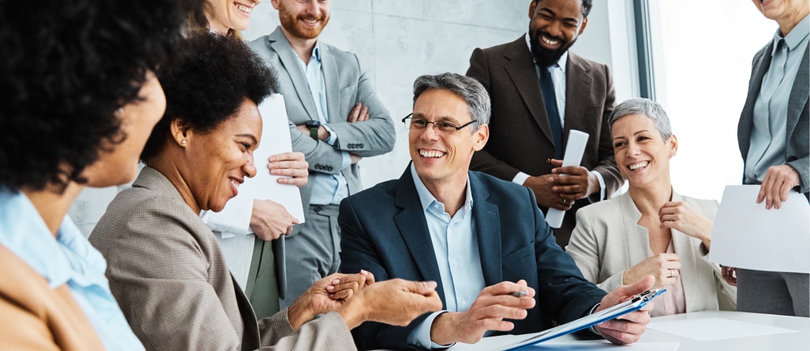 a group of people happily discussing business